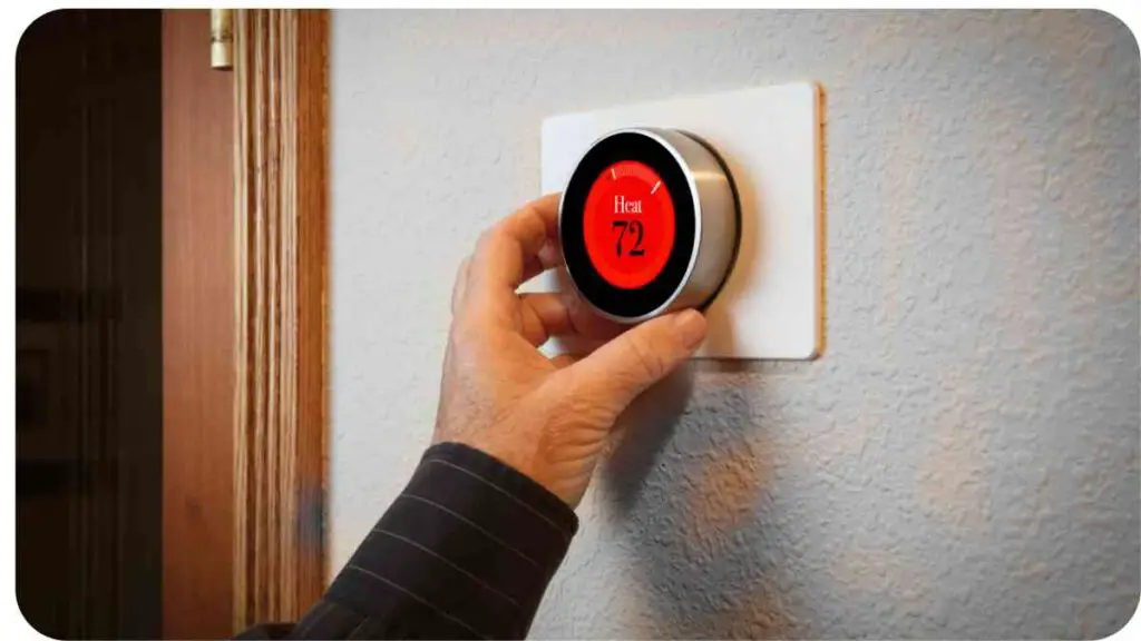 a person is adjusting the thermostat on a wall